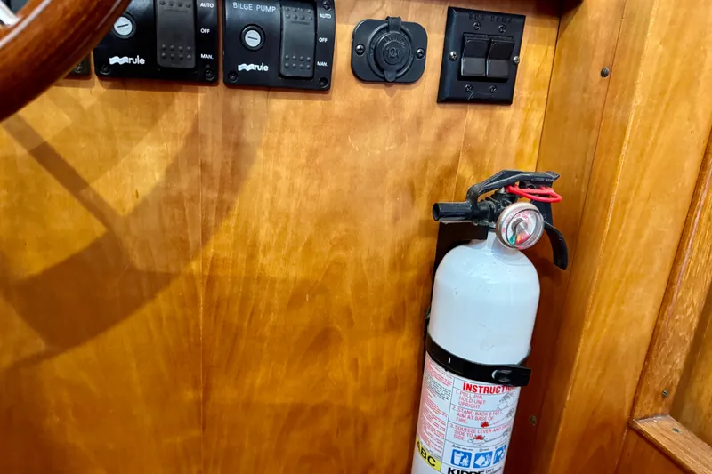 Slide: The Image of Control panel and fire extinguisher on 2001 Sabre Sedan Bridge boat. - 56