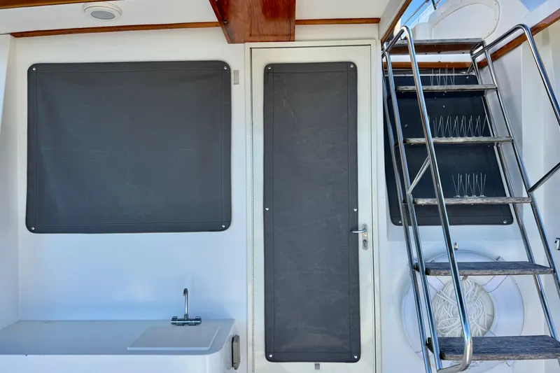 Slide: The Image of 2001 Sabre Sedan Bridge interior with stairs, door, and sink area. - 6