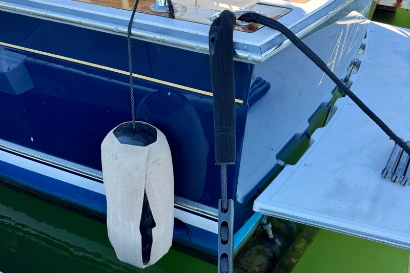 Slide: The Image of 2001 Sabre Sedan Bridge boat with fender and dock line. - 60