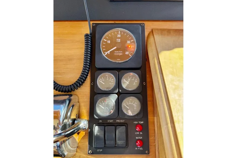 Slide: The Image of Control panel of a 2001 Sabre Sedan Bridge boat with gauges and switches. - 61