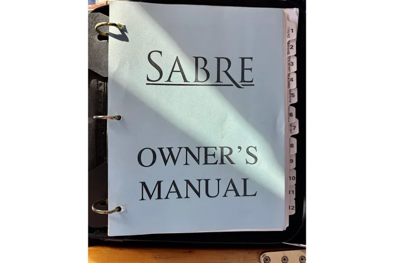 Slide: The Image of Owner's manual for 2001 Sabre Sedan Bridge, binder with tabbed sections. - 70