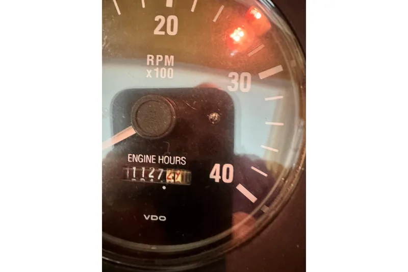 Slide: The Image of Close-up of a 2001 Sabre Sedan Bridge tachometer showing 1127 engine hours. - 72
