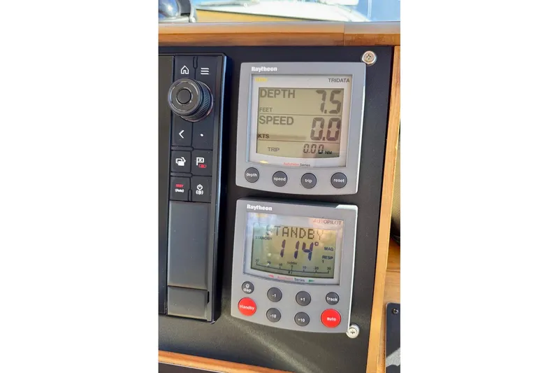 Slide: The Image of Control panel of a 2001 Sabre Sedan Bridge with Raytheon navigation displays. - 73