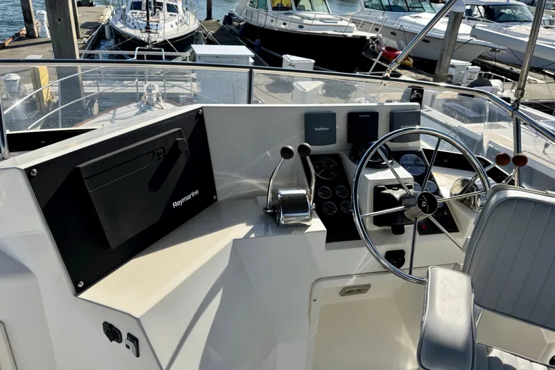 Slide: The Image of 2001 Sabre Sedan Bridge helm with Raymarine electronics, docked at marina. - 8
