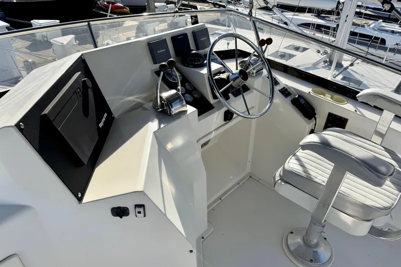 Slide: The Image of Helm of 2001 Sabre Sedan Bridge with steering wheel and controls, docked at marina. - 9