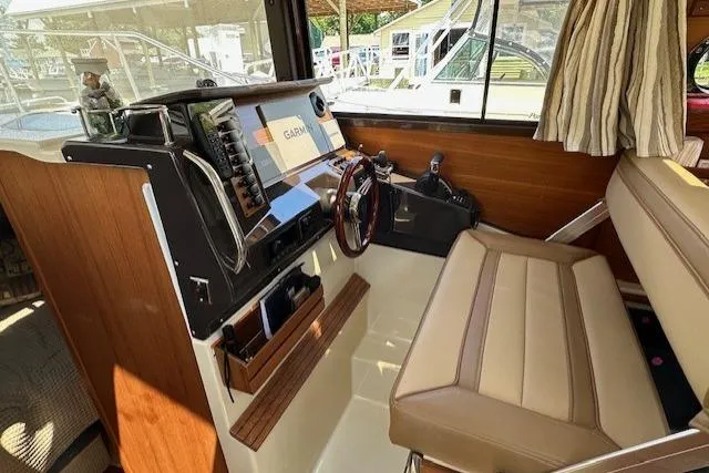 Slide: The Image of 2024 Ranger Tugs R-27 helm with modern controls and comfortable seating. - 14