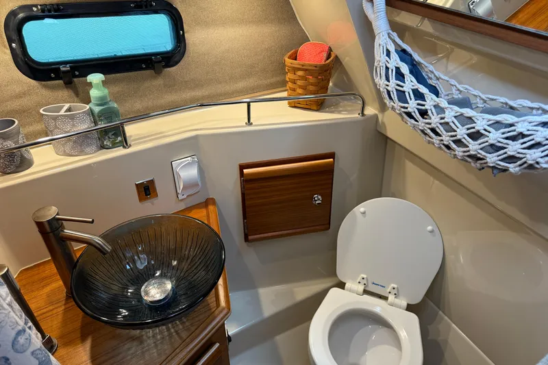 Slide: The Image of Interior of 2024 Ranger Tugs R-27 with wooden hooks and Fusion speaker. - 24