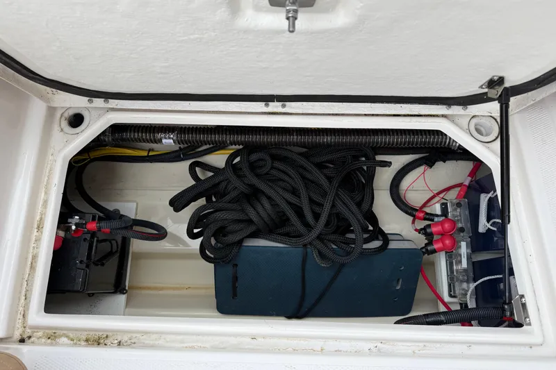 Slide: The Image of 2024 Ranger Tugs R-27 storage compartment with equipment and supplies. - 30