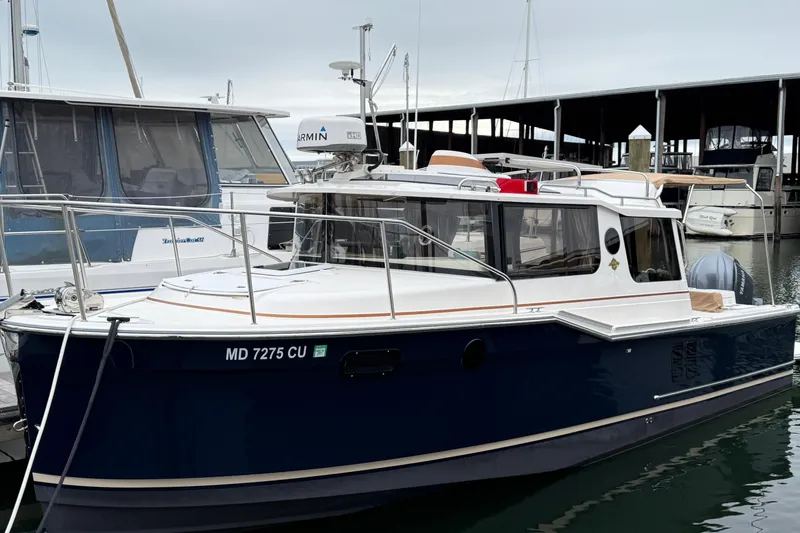Slide: The Image of 2024 Ranger Tugs R-27 with Garmin xHD radar and boat canopy in background. - 33