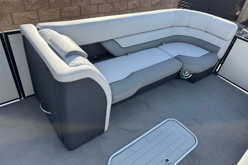 Slide: The Image of Luxurious seating on 2020 Godfrey Monacco 255 SD boat, featuring sleek gray upholstery. - 12