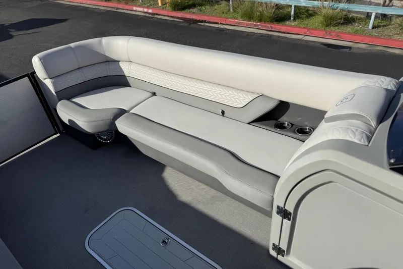 Slide: The Image of 2020 Godfrey Monacco 255 SD boat interior with plush seating and cup holders. - 13