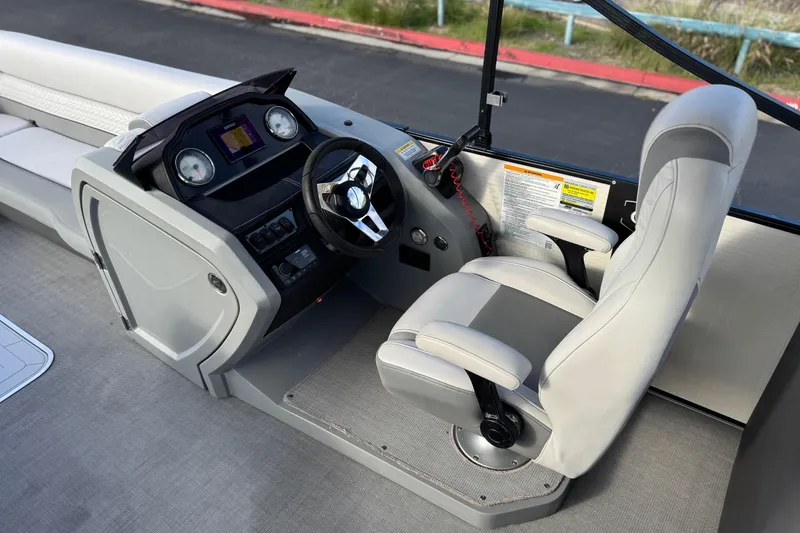 Slide: The Image of Captain's seat and helm of 2020 Godfrey Monacco 255 SD boat, featuring modern controls. - 26