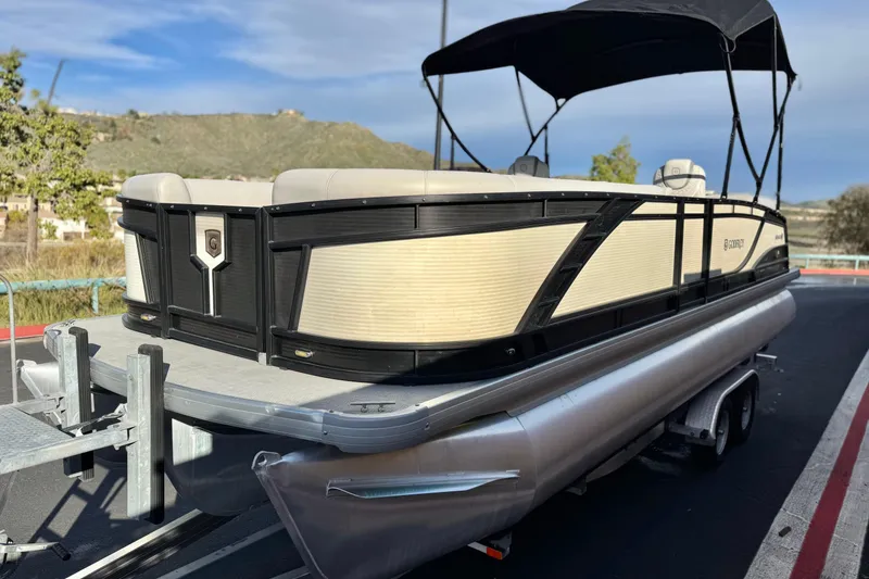 Slide: The Image of 2020 Godfrey Monacco 255 SD pontoon boat on trailer, parked outdoors. - 3