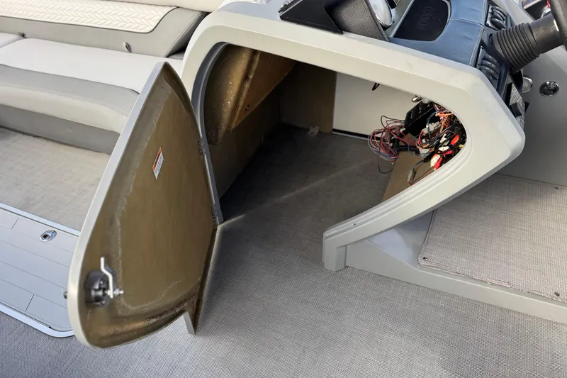 Slide: The Image of Open storage compartment on 2020 Godfrey Monacco 255 SD boat, showing interior wiring. - 34