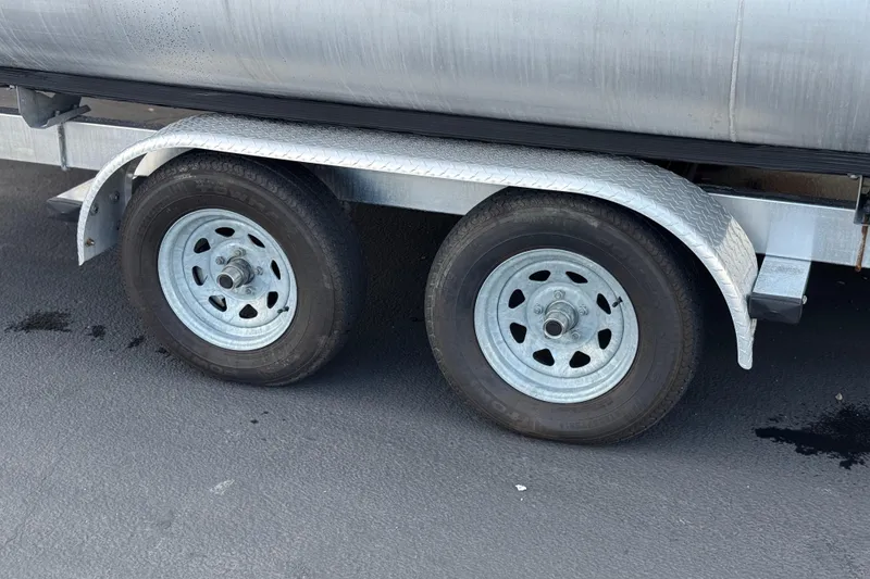 Slide: The Image of Trailer wheels of a 2020 Godfrey Monacco 255 SD on asphalt surface. - 35
