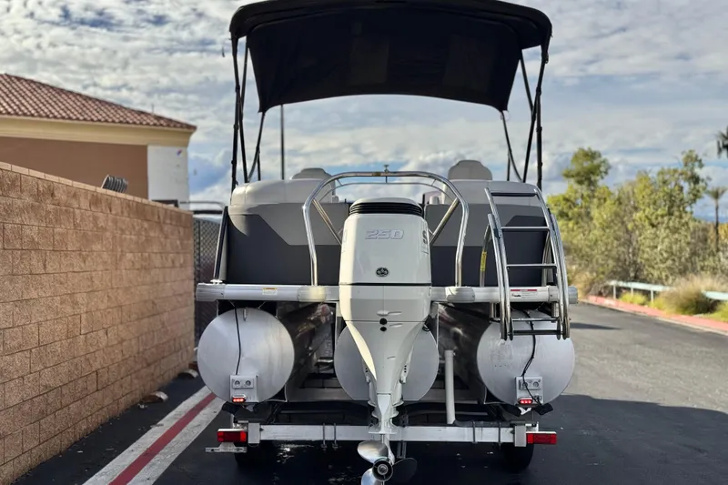 Slide: The Image of 2020 Godfrey Monacco 255 SD pontoon boat with outboard motor, parked on trailer. - 5