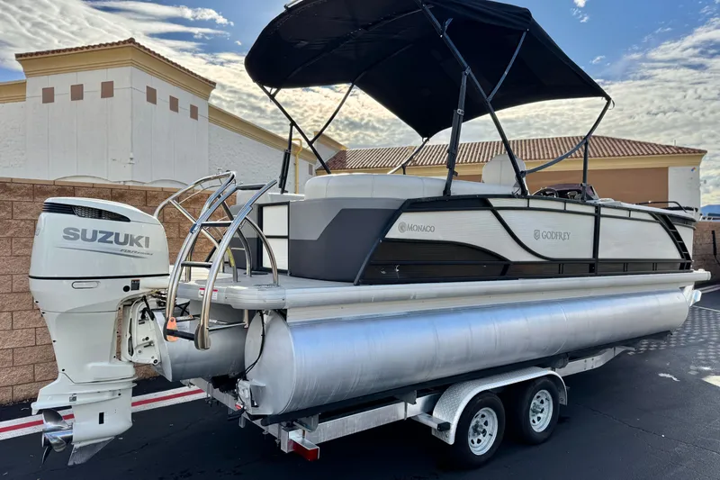 Slide: The Image of 2020 Godfrey Monacco 255 SD pontoon boat with Suzuki outboard motor on trailer. - 6