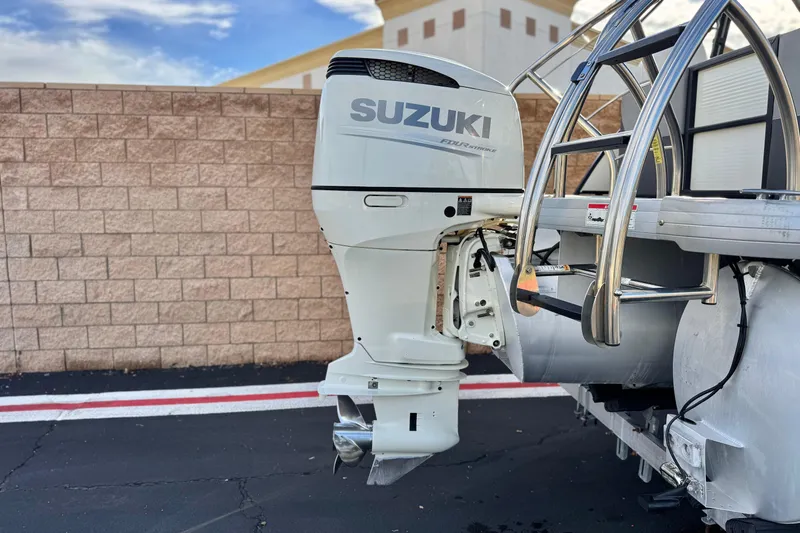 Slide: The Image of Outboard motor on 2020 Godfrey Monacco 255 SD boat, parked near a brick wall. - 7