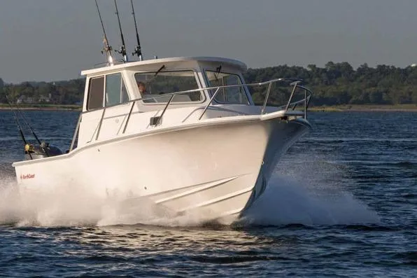 Slide: The Image of 2023 NorthCoast 255HT boat cruising on water with fishing rods. - 1