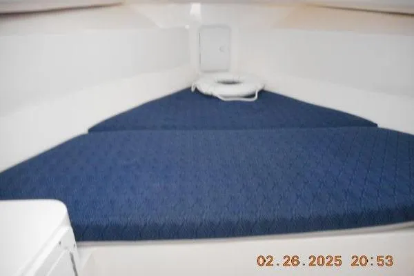 Slide: The Image of 2023 NorthCoast 255HT cabin interior with blue cushioned seating. - 10