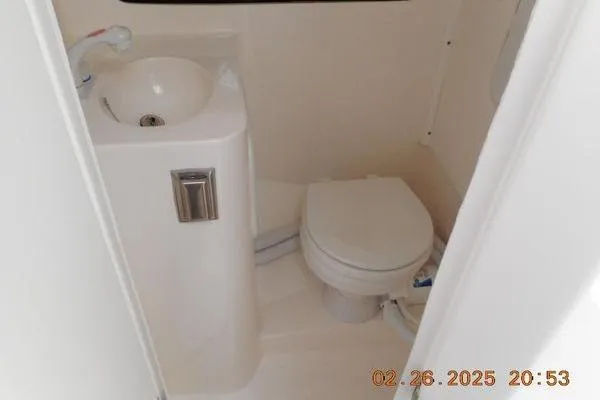 Slide: The Image of Compact bathroom in 2023 NorthCoast 255HT boat with sink and toilet. - 11