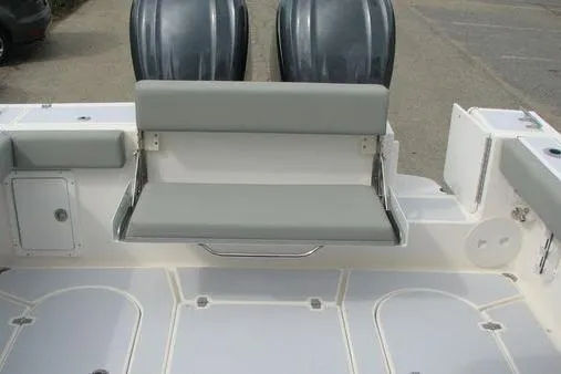 Slide: The Image of 2023 NorthCoast 255HT boat with foldable seating and dual outboard motors. - 13