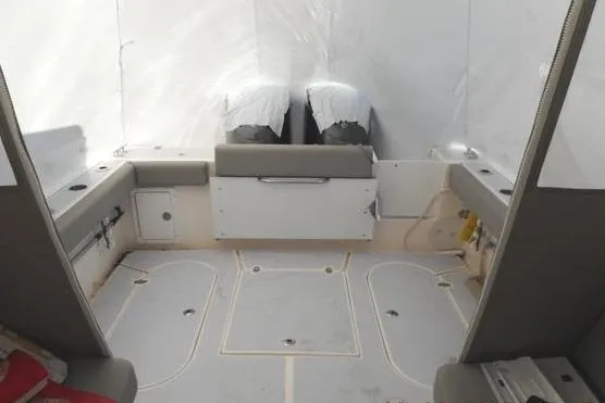 Slide: The Image of 2023 NorthCoast 255HT boat interior with dual engines and spacious seating area. - 14