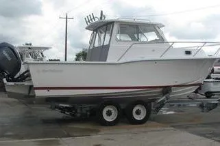 Slide: The Image of 2023 NorthCoast 255HT boat on trailer, side view, overcast sky. - 4