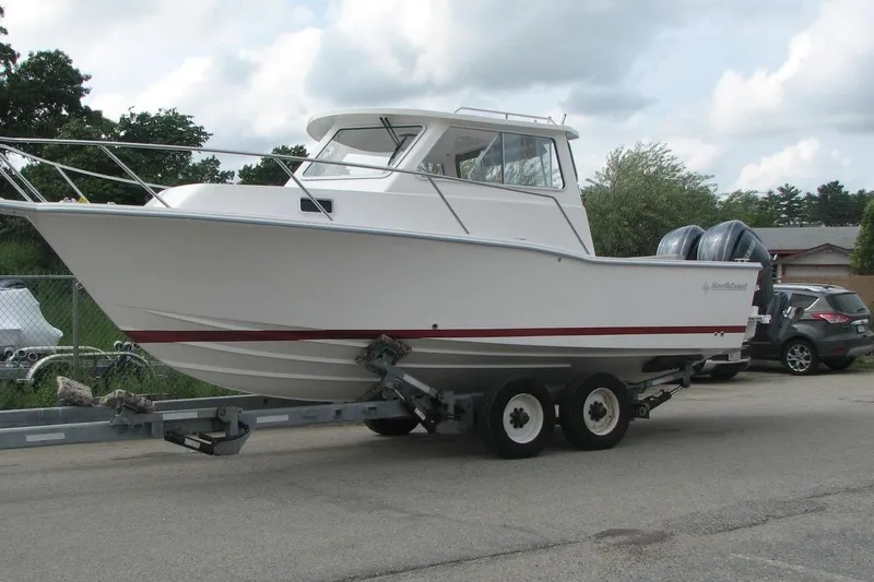 Slide: The Image of 2023 NorthCoast 255HT boat on trailer, featuring dual outboard motors. - 5