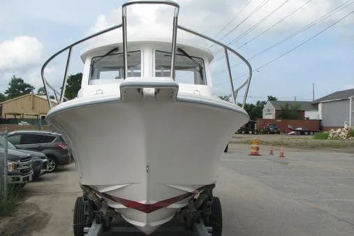 Slide: The Image of 2023 NorthCoast 255HT boat on trailer, front view in parking lot. - 7