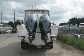 Slide: The Image of 2023 NorthCoast 255HT boat with dual outboard motors, parked on a cloudy day. - 8