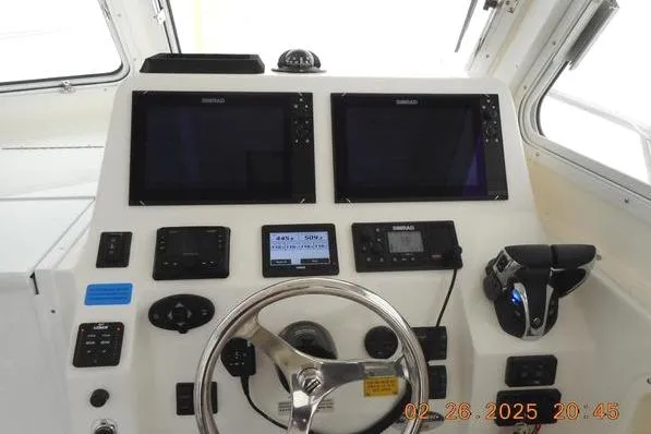 Slide: The Image of 2023 NorthCoast 255HT boat helm with dual screens and modern controls. - 9