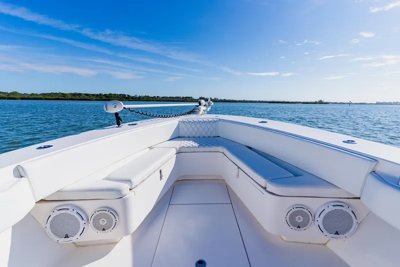 Slide: The Image of 2025 Contender 32 ST boat interior with white seating, on calm blue water. - 12