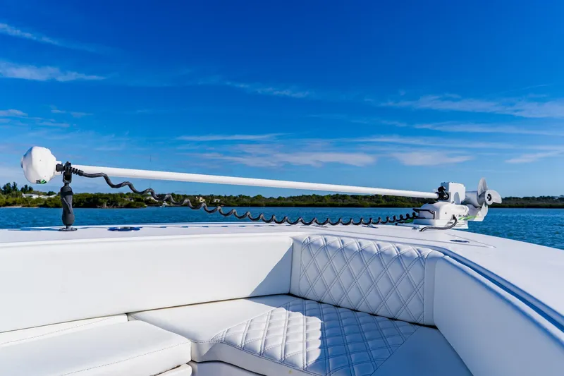 Slide: The Image of 2025 Contender 32 ST boat with advanced trolling motor on calm water. - 13