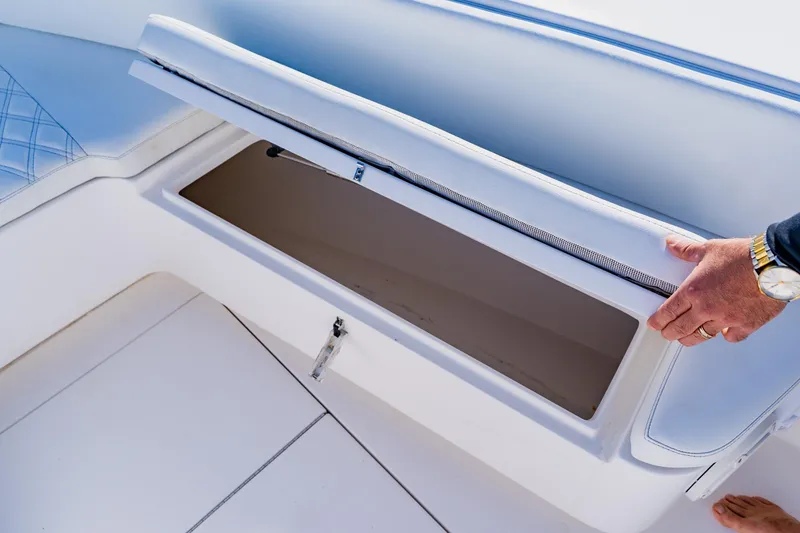 Slide: The Image of Contender 32 ST 2025 boat storage compartment with cushioned seating. - 15