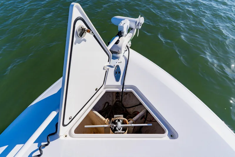 Slide: The Image of Bow of 2025 Contender 32 ST boat with open anchor hatch on water. - 16