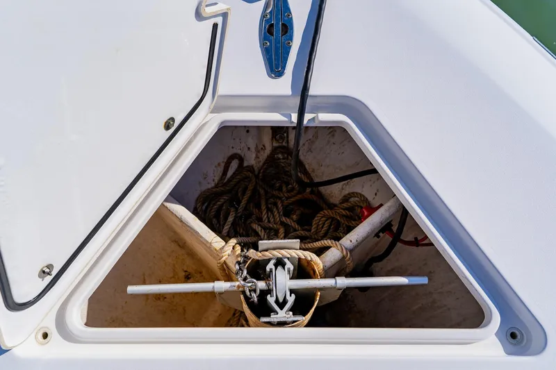 Slide: The Image of Anchor storage compartment on 2025 Contender 32 ST boat, featuring ropes and anchor equipment. - 17