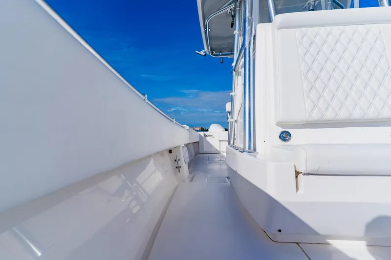 Slide: The Image of 2025 Contender 32 ST boat with sleek white interior and blue sky background. - 22