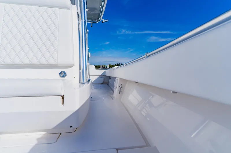 Slide: The Image of 2025 Contender 32 ST boat interior with white seating and clear blue sky. - 23