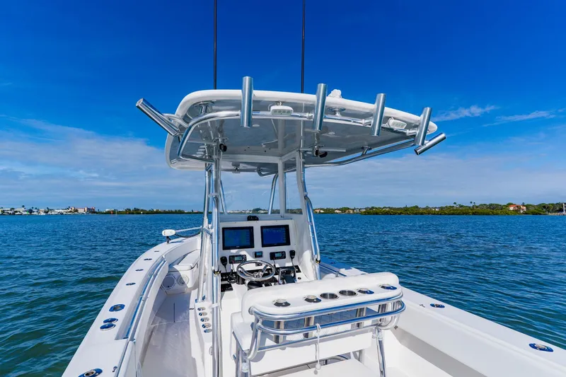 Slide: The Image of 2025 Contender 32 ST boat on calm water, featuring advanced navigation equipment. - 24