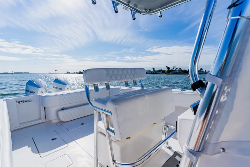 Slide: The Image of 2025 Contender 32 ST boat interior with dual Mercury engines, on a sunny day at sea. - 26