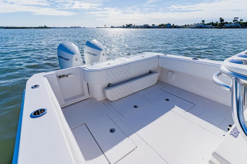 Slide: The Image of 2025 Contender 32 ST boat with dual Mercury engines on calm water. - 31