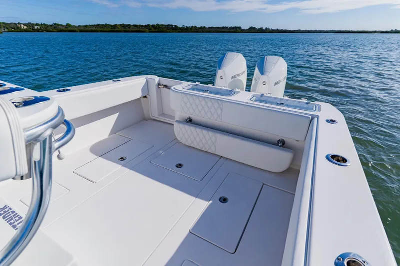 Slide: The Image of 2025 Contender 32 ST boat with dual Mercury engines on calm water. - 32