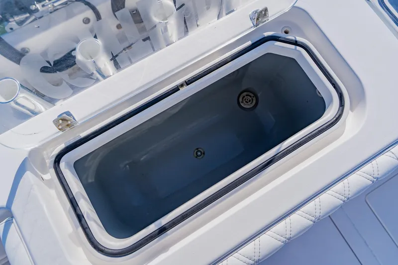 Slide: The Image of Contender 32 ST 2025 boat livewell, open lid, white interior, marine equipment. - 36