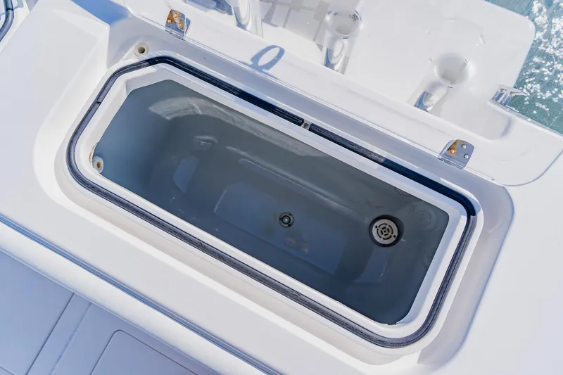 Slide: The Image of Livewell on 2025 Contender 32 ST boat, open lid, white interior. - 37