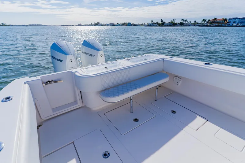 Slide: The Image of 2025 Contender 32 ST boat with dual Mercury engines on calm water. - 39