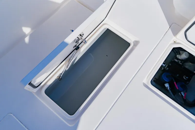 Slide: The Image of Open storage compartments on a 2025 Contender 32 ST boat deck. - 41
