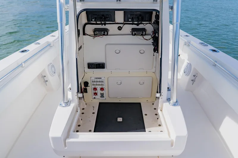 Slide: The Image of 2025 Contender 32 ST boat console with electronic controls and storage compartments. - 45