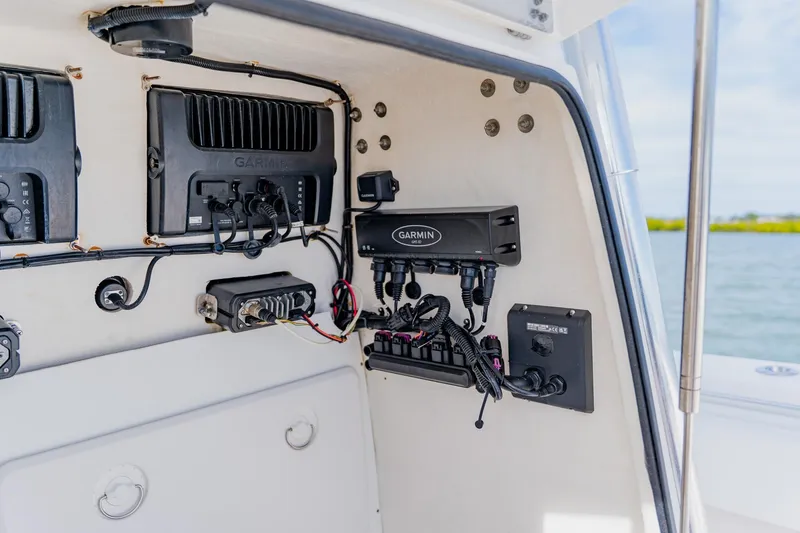 Slide: The Image of 2025 Contender 32 ST boat electronics panel with Garmin devices and wiring. - 46