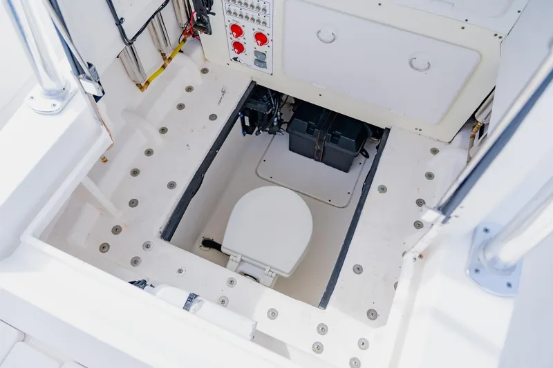 Slide: The Image of 2025 Contender 32 ST boat interior with a built-in marine toilet. - 48